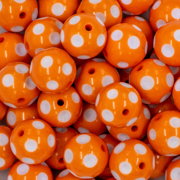 close up view of a pile of 20mm Orange with White Polka Dots Acrylic Bubblegum Beads