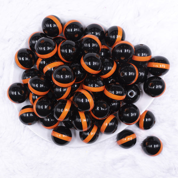 top view of a pile of 20mm Orange Band on Black Bubblegum Beads