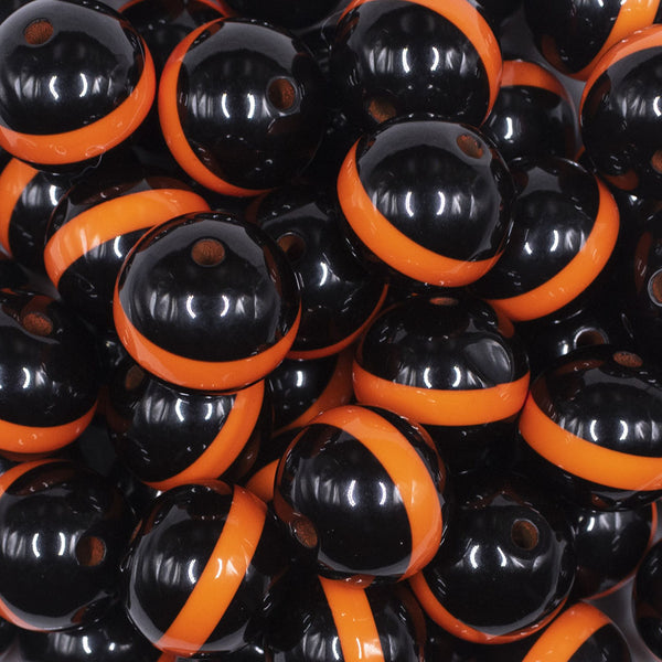close up view of a pile of 20mm Orange Band on Black Bubblegum Beads