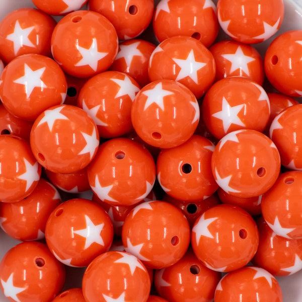 close up view of a pile of 20mm Orange with White Stars Bubblegum Bead