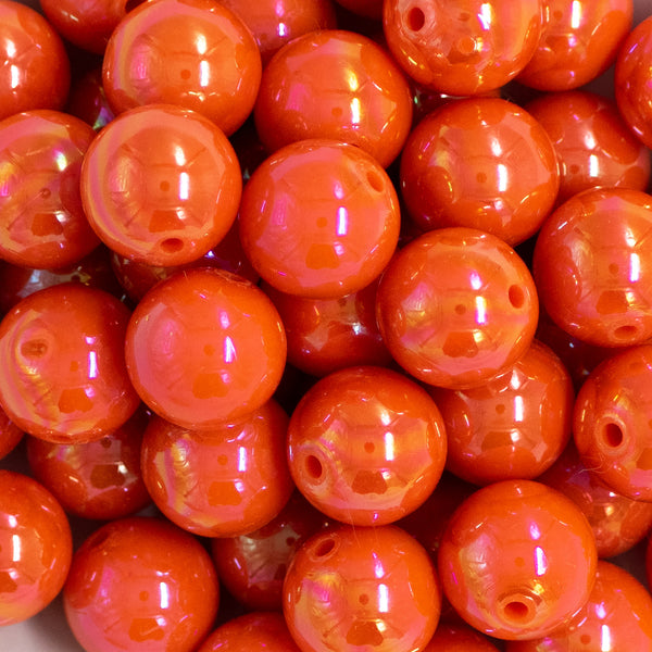 Close up view of a pile of 20mm Orange Solid AB Bubblegum Beads
