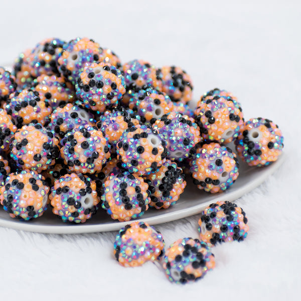 front view of a pile of 20mm Purple, Orange & Black Confetti Rhinestone AB Bubblegum Beads