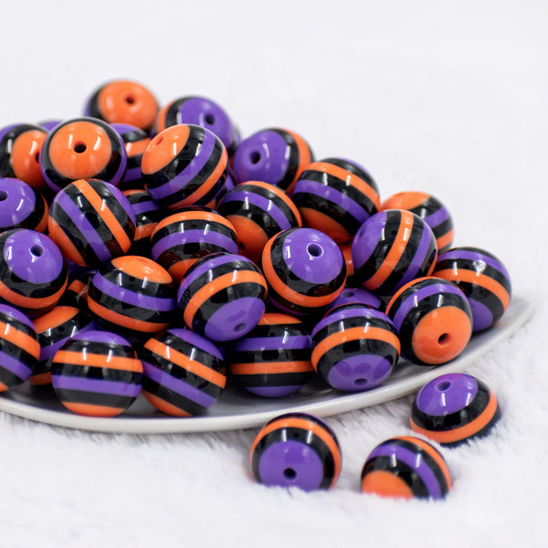 front view of a pile of 20mm Orange, Purple & Black Stripe Bubblegum Beads