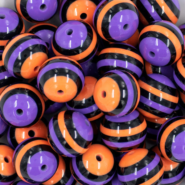 close up view of a pile of 20mm Orange, Purple & Black Stripe Bubblegum Beads