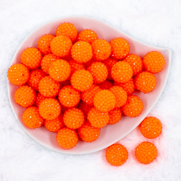 top of a pile of 20mm Neon Orange Rhinestone Bubblegum Beads