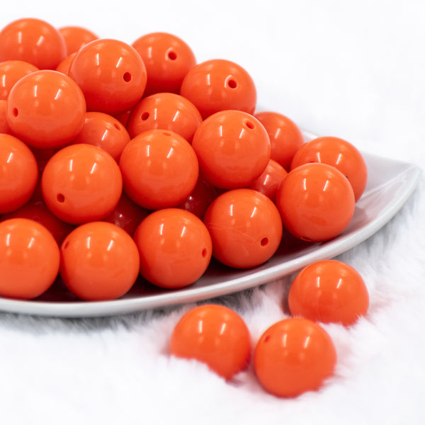 front of a pile of 20mm Orange Solid Bubblegum Beads