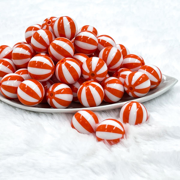 front view of a pile of 20mm Orange with White Stripe Beach Ball Bubblegum Beads