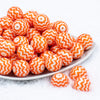Front view of a pile of 20mm Orange Chevron with White Matte Chunky Acrylic Bubblegum Beads