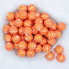 Top view of a pile of 20mm Orange Chevron with White Matte Chunky Acrylic Bubblegum Beads