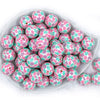 top view of a pile of 20mm Bubblegum white beads printed with pastel pink, green, and purple Flowers 