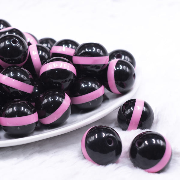 front view of a pile of 20mm Pink Band on Black Bubblegum Beads
