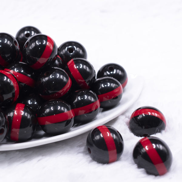 front view of a pile of 20mm Red Band on Black Bubblegum Beads