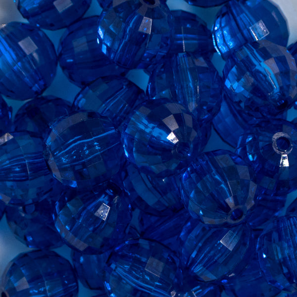 Close up view of a pile of 20mm Royal Blue Transparent Disco Faceted Pearl Bubblegum Beads