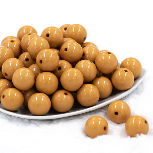 front view of a pile of 20mm Sandstone Brown Solid Bubblegum Beads