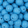 Close up view of a pile of 20mm Maya Blue Solid Chunky Acrylic Bubblegum Beads