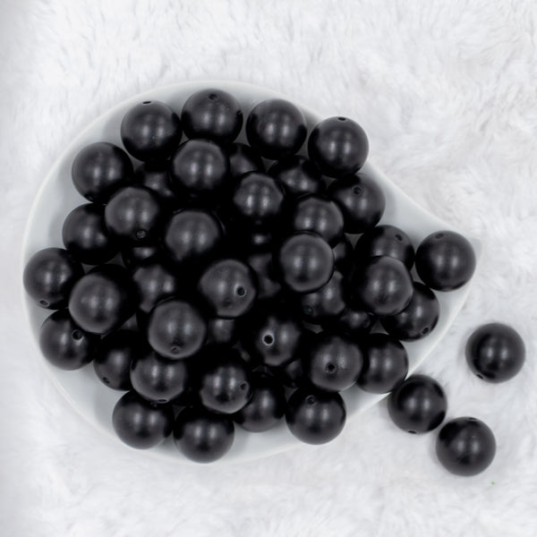 top view of many 20mm Black Matte Solid Chunky Acrylic Bubblegum Beads in white dish