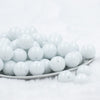 front view of a stack of 20mm Bright White Solid Chunky Bubblegum Beads in a white dish