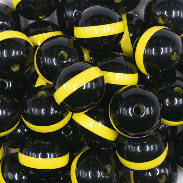 close up view of a pile of 20mm Yellow Band on Black Bubblegum Beads
