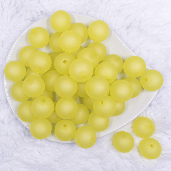 Top view of a pile of 20mm yellow frosted bubblegum beads