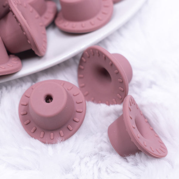 macro view of mauve taupe silicone cowboy hats pink