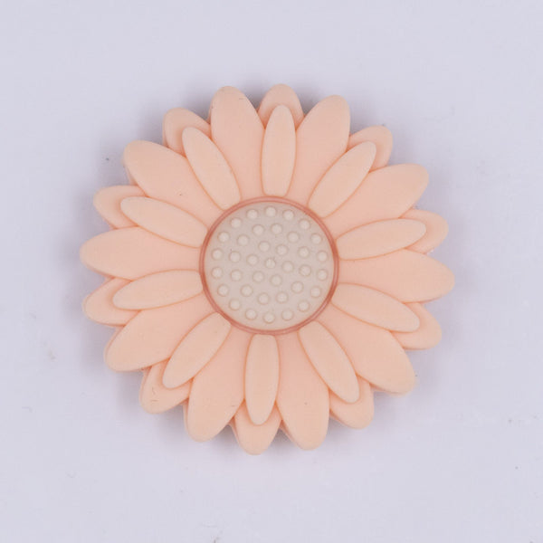 Top view of a peach 30mm silicone daisy flower beads