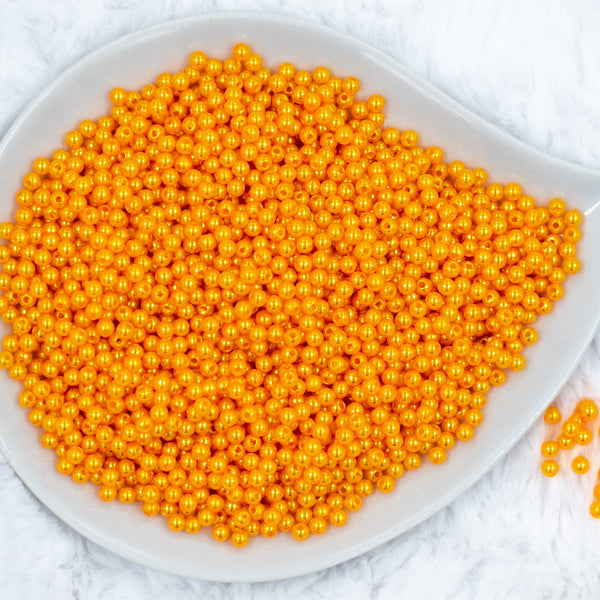 Top view of a pile of 4mm Mustard Yellow Pearl Spacer Beads [100-120 Count]
