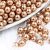 close up view of a pile of 6mm Champagne Gold Pearl Spacer Beads