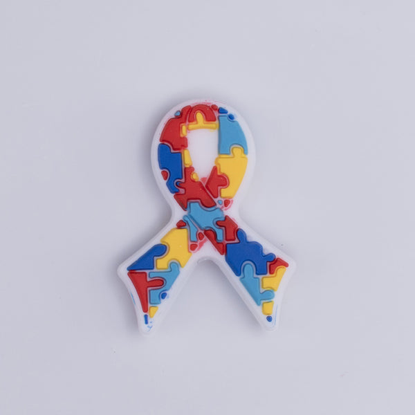 top view of a pile of Autism Awareness Ribbon Silicone Focal Bead Accessory