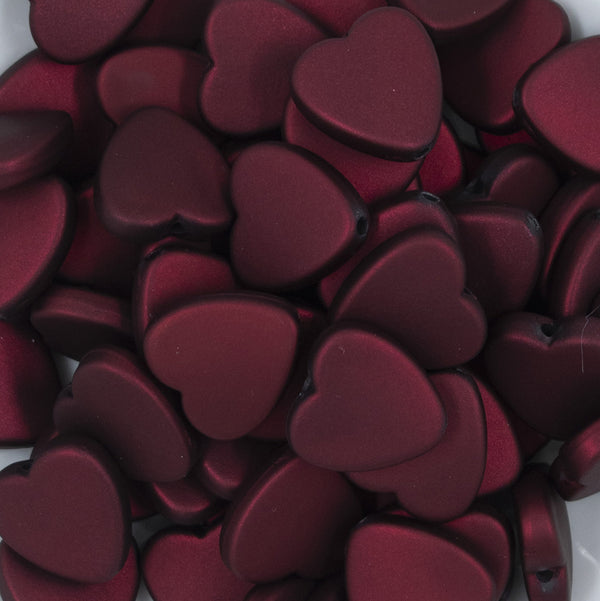 Close up view of a pile of 20mm Dark Red Rubberized Style Heart Beads