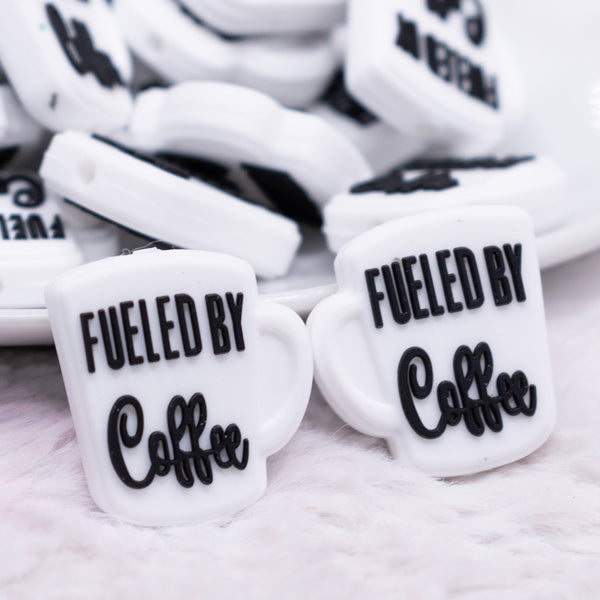 close up view of a pile of Fueled By Coffee Black on White Silicone Focal Bead Accessory