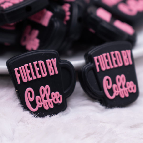 close up view of a pile of Fueled By Coffee Pink on Black Silicone Focal Bead Accessory