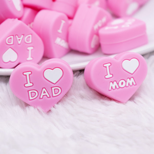close up view of I Love Mom / Dad Pink Heart Silicone Focal Bead Accessory