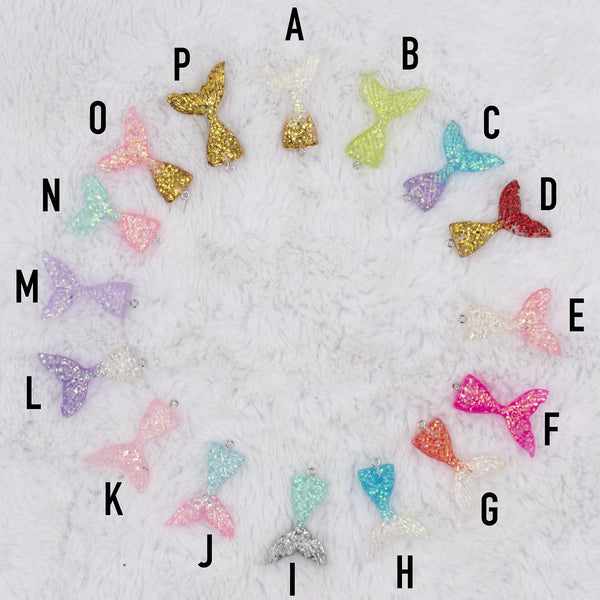 Top view of a pile of Glitter Mermaid Fish Tail Shape Pendant - 46mm [1 Count]