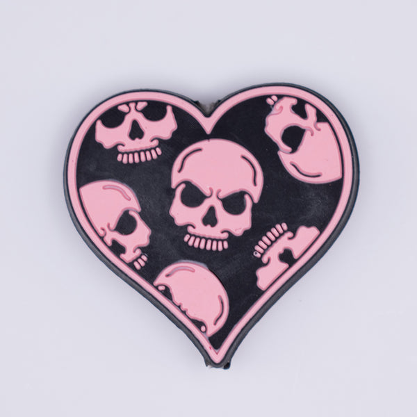 Macro view of Black heart with Pink Skull Silicone Focal Bead Accessory