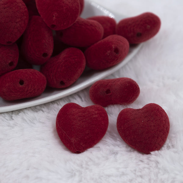 Macro view of pile of 25mm Red Flocked Style Heart Beads