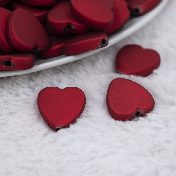 Micro view of a pile of 20mm Red Rubberized Style Heart Beads