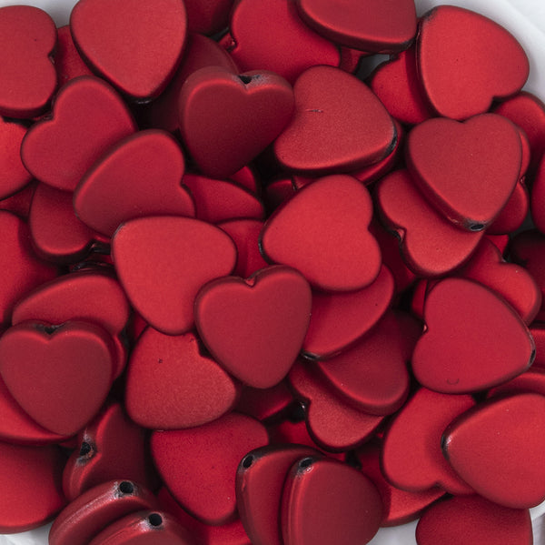 Close up view of a pile of 20mm Red Rubberized Style Heart Beads