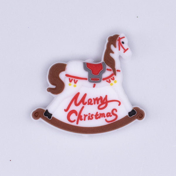 Top view of a Close up view of a pile of Merry Christmas Rocking Horse Silicone Focal Bead Accessory - 27mm x 32mm