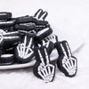 Front view of a pile of Skeleton Hand Peace Sign Silicone Focal Bead Accessory