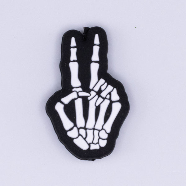 Top view of a Skeleton Hand Peace Sign Silicone Focal Bead Accessory