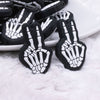 Close up view of a pile of Skeleton Hand Peace Sign Silicone Focal Bead Accessory