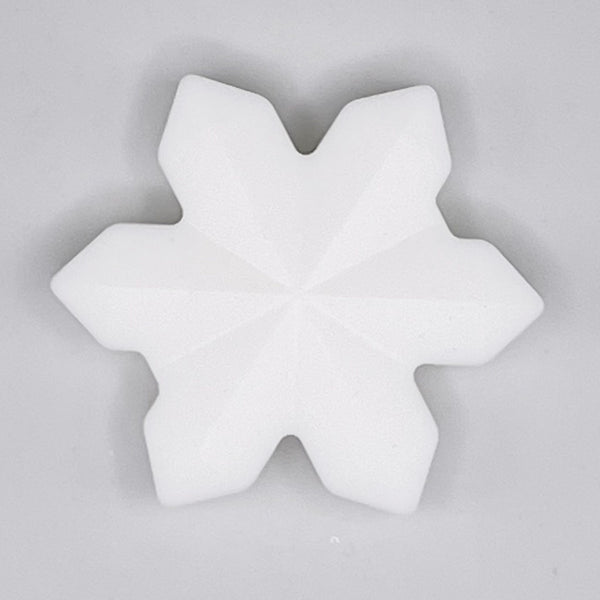 top view of a pile of White Snowflake Silicone Focal Bead Accessory - 40mm x 40mm