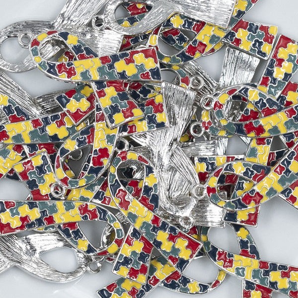 Close up view of a pile of Autism Awareness Ribbon Alloy Enamel Pendant 39mm