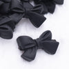 close up view of a pile of 27mm Black Bow Knot silicone bead