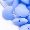 Close up view of a pile of 20mm Blue heart silicone bead