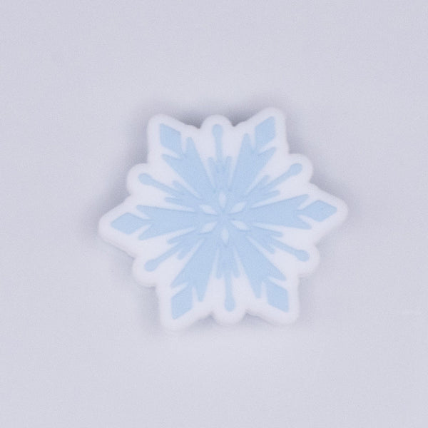 top view of a pile of Blue Snowflake Silicone Focal Bead Accessory - 28mm x 28mm