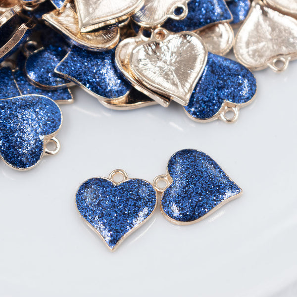 Front view of a pile of Blue Glitter Enamel Heart Charm 15mm