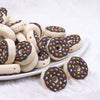 front view of a pile of Donut with Brown Icing and Sprinkles Silicone Focal Bead Accessory - 28mm