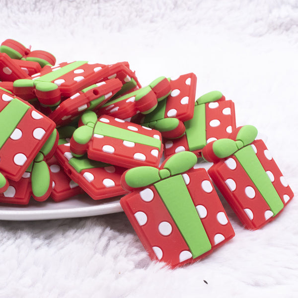 front view of a pile of Christmas Gift Silicone Focal Bead Accessory -31mm x 30mm