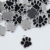 Top view of a pile of Black Paw Print Full Enamel Charm 17x16mm